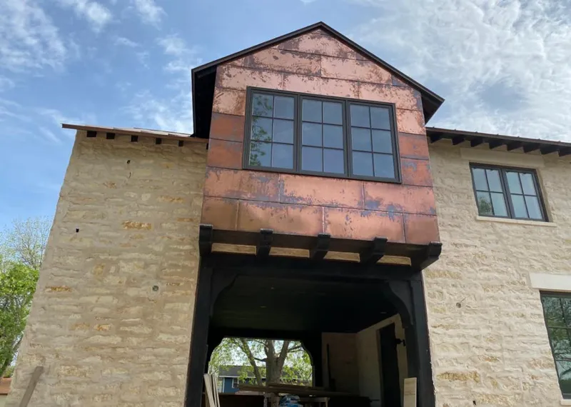 Copper metal panel facade on a stone building for Skylight Installation in Cherry Creek