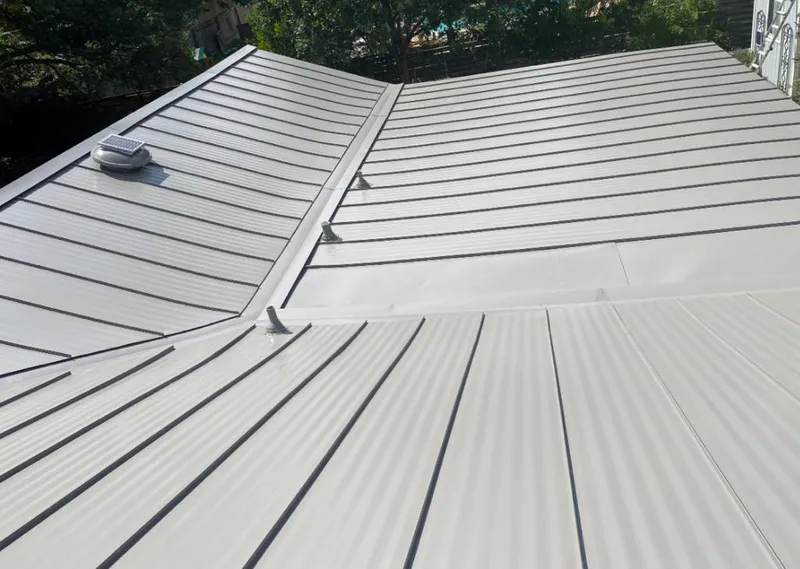 Solar attic fan installed on a metal roof for Roof Ventilation in Cherry Creek